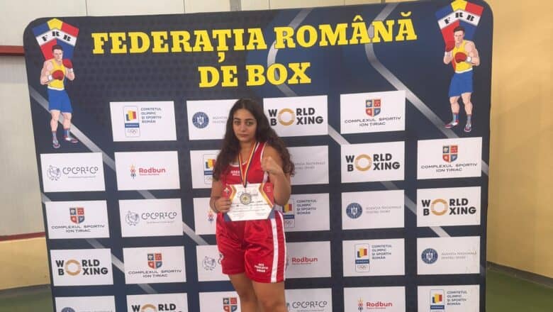 Sofia Filip, boxeriță din Sibiu, cu medalia de argint la Campionatul Național, în fața panoului Federației Române de Box